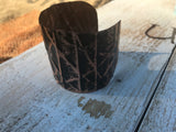 Black form-folded  2 inch wide copper cuff with black removed so beauty of the copper shines through
