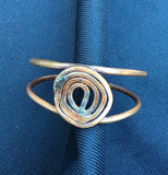 copper coil on two wires that shapes into a very comfortable copper band