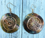 Flamed copper with daisy pattern placed into the center