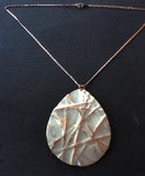 large teardrop on sandstone colored necklace that has been form-folded