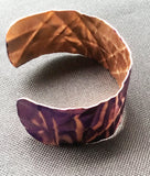 side view of purple 1 inch copper cuff